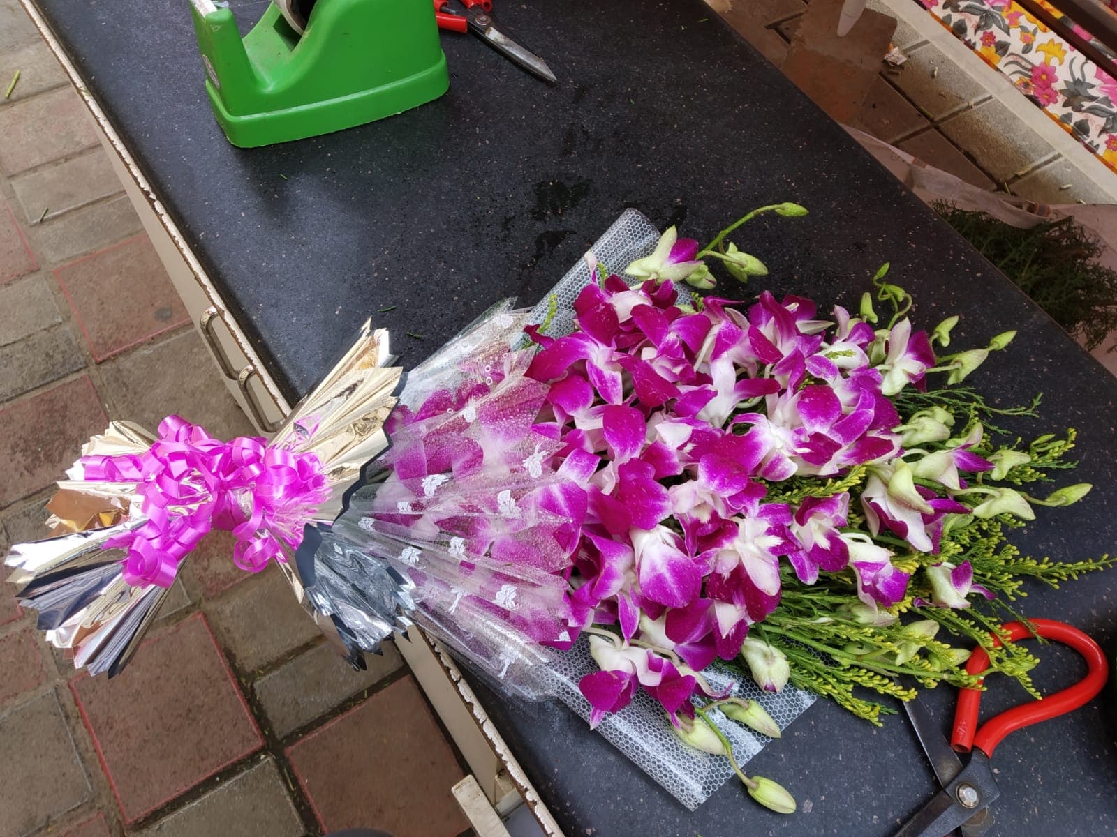Peaceful purple orchids and serenity sympathy tribute sheaf